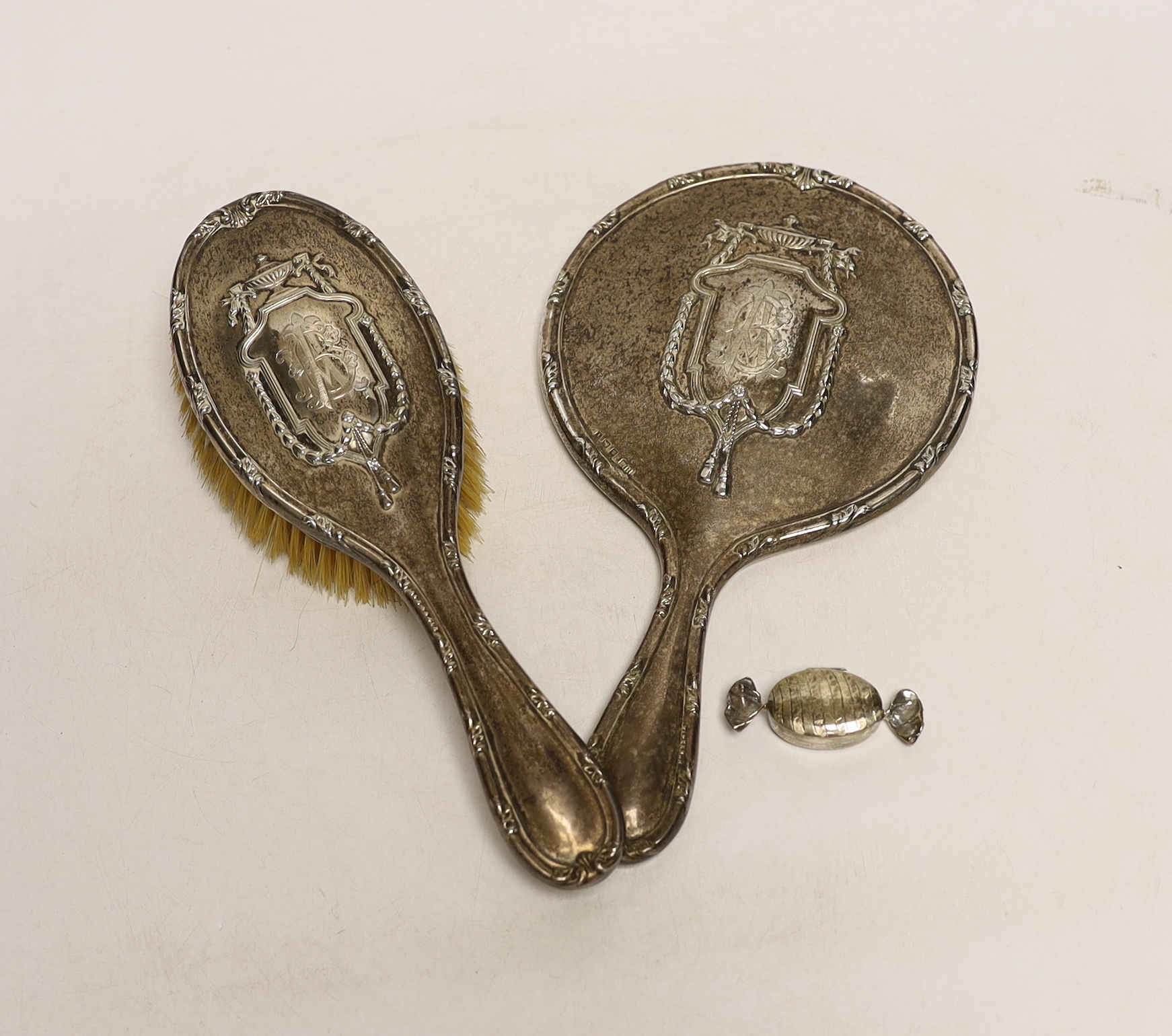 An Edwardian silver mounted hand mirror and hair brush, Henry Matthews, Birmingham, 1908 and a modern 925 pill box modelled as a wrapped sweet.